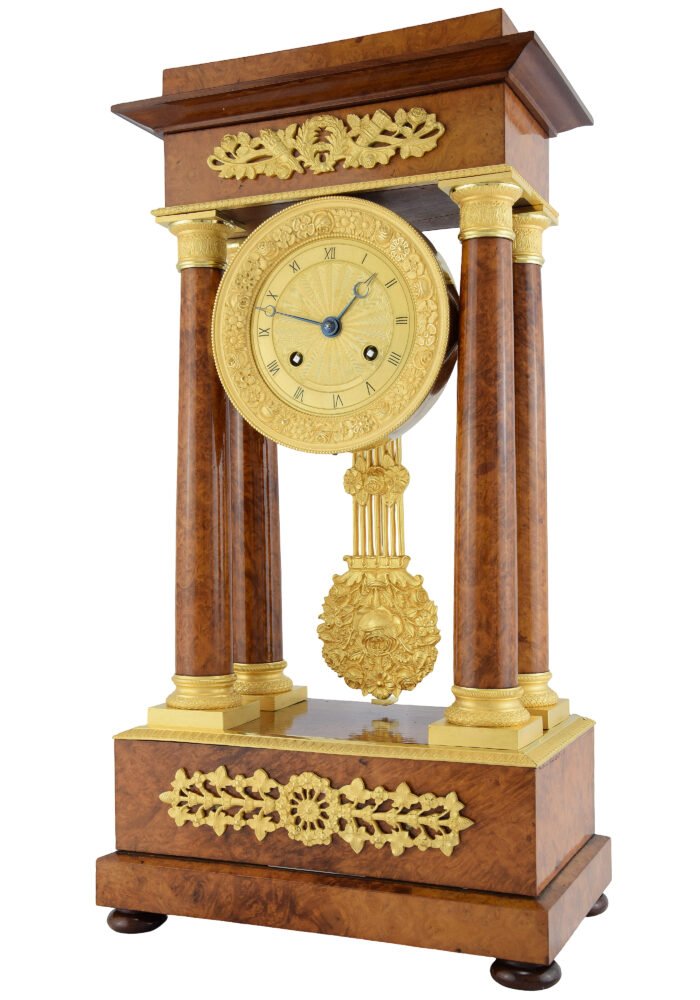 Pendule portique bois de loupe Charles X 1840